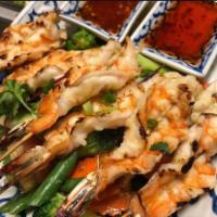 60. Goong Ping Specialty · Hand-peeled jumbo shrimp grilled on bamboo skewers.