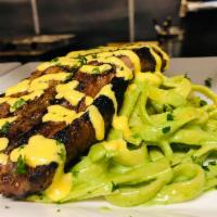 Tallarines Verdes Bistec Apanado · 10oz Grilled New York steak served with linguine tossed in Peruvian pesto cream sauce.