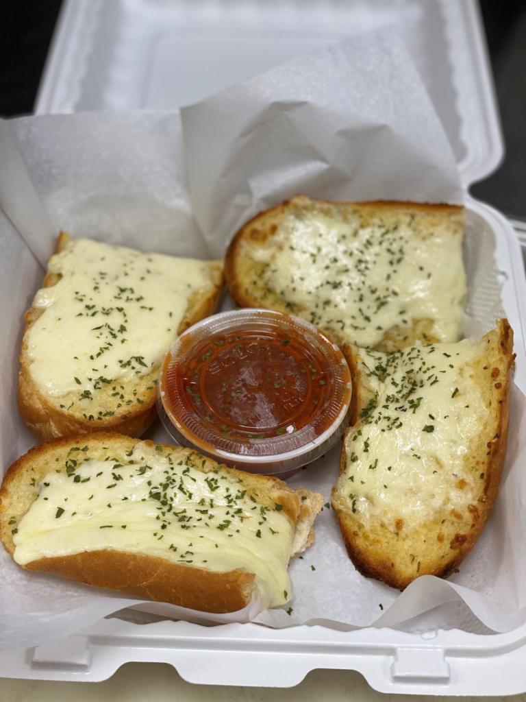 Garlic Bread with Cheese · Our garlic bread topped with 100% mozzarella cheese. Served with marinara dipping sauce.