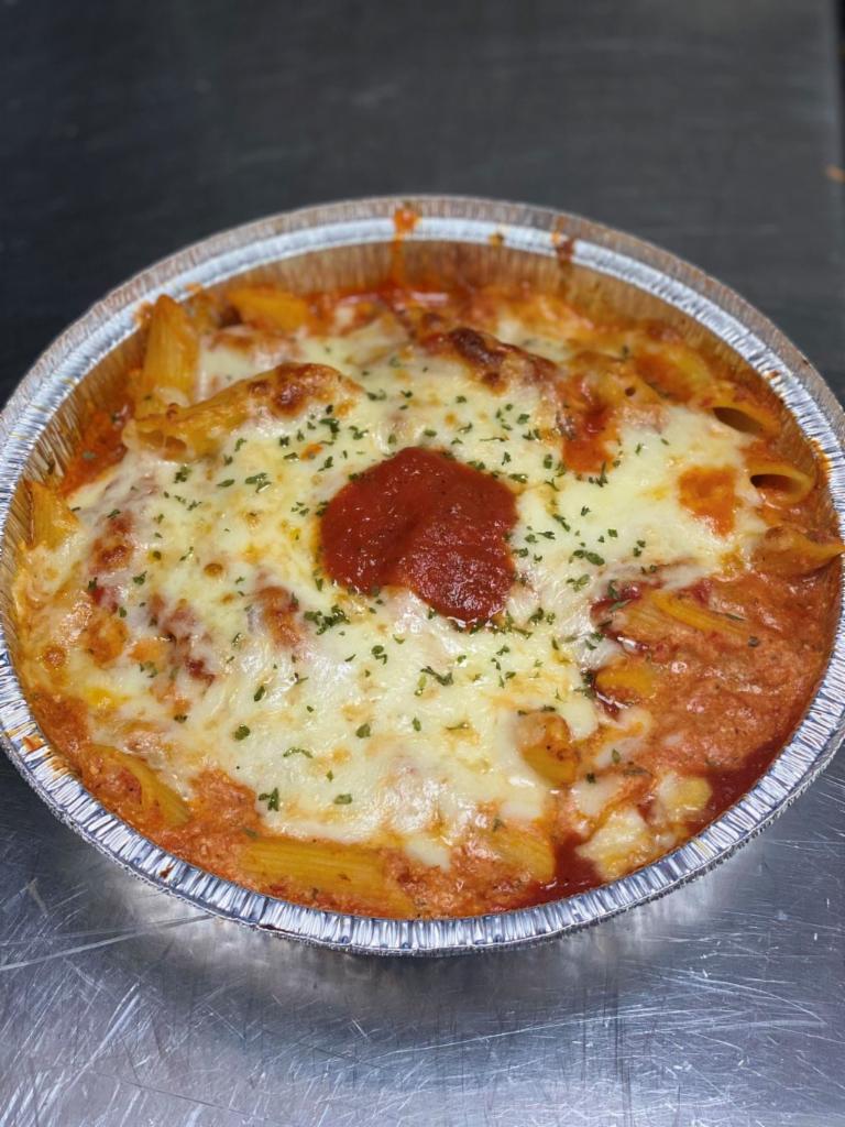 Baked Ziti · Penne noodles mixed with our tomato sauce and ricotta cheese, then topped with mozzarella cheese and baked to perfection. Served with salad and garlic bread.