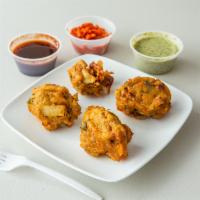 Vegetable Pakora · 5 pieces. Fresh vegetable fitters of spinach, potato, green pepper and onion. Vegan.