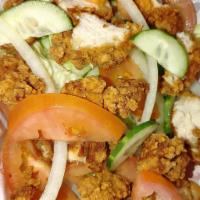 Crispy Chicken Salad · Iceberg lettuce, tomatoes, cucumbers and onion topped with crispy chicken nuggets