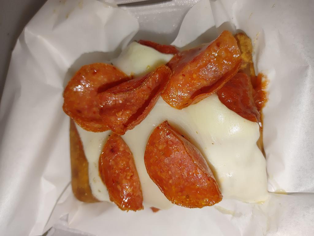Pizza Puff Supreme · Pork, pizza sauce, mozzarella cheese and spices wrapped in a tortilla and deep fried then topped with marinara, pepperoni and more melted mozzarella cheese