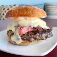 Wagyu Pastrami Burger · Wagyu Pastrami and Angus beef patty topped with Swiss cheese and Thousand Island dressing on...