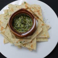 Spinach Dip · Baby spinach simmered in Monterey Jack and cream cheese and served with freshly baked flatbr...