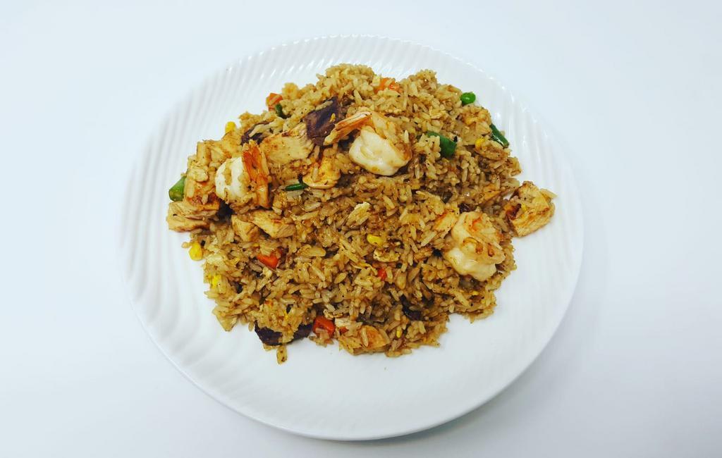 Combo Fried Rice · Steamed rice stir-fried in a wok with chicken, shrimp, beef, onions, peas, green beans, carrots and corn.