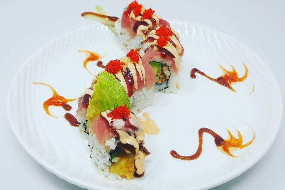 Red Dragon Roll · Shrimp tempura, eel, avocado, 
cucumber inside topped with fresh 
seared tuna, tempura flakes and 
tobiko
