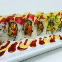 Rasta Roll · Spicy yellowtail, king crab, avocado 
and cucumber topped with salmon, 
tuna avocado and tem...