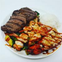 Sea Island Combination · 6 oz. lobster tail, Angus ribeye and grilled shrimp. Served with choice of side, steamed ric...