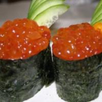Ikura (Salmon Roe) Sushi · Roe (fish eggs) of salmon on top of  sushi rice wrapped in seaweed paper.