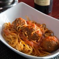 Spaghetti Con Polpette  · Meatballs in tomato sauce.