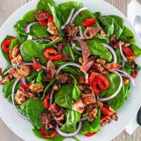 Spinach Salad · Baby spinach, chopped bacon, roasted peppers, olives, red onions and glazed walnuts in a ble...