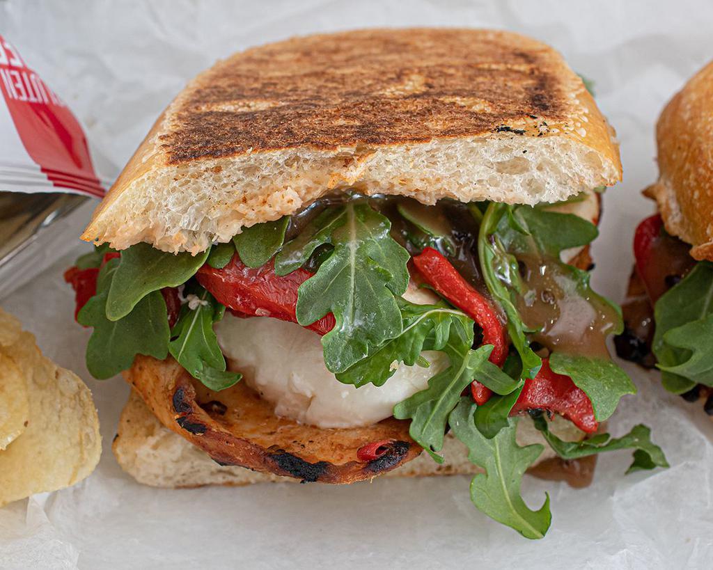 The Grilled Chicken Panini · Fresh mozzarella, roasted peppers, arugula and balsamic vinaigrette.