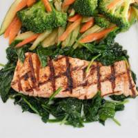 Grilled Salmon · Served over sauteed spinach and vegetables.