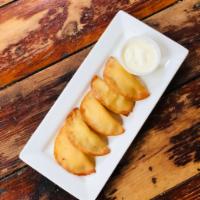 Crispy Pierogis · Five deep fried potato filled dumplings. Served with Sweet Sour Cream Sauce
