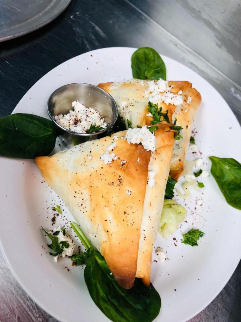 Spanakopita · Baked phyllo dough with fresh spinach and feta. Vegetarian.