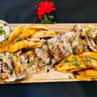 Chicken Shawarma Wrap · Shredded marinated chicken, topped with onions and parsley served with your choice fries or ...