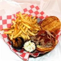 Smoked Pulled Pork Sandwich · Boston butt is softly pulled apart and marinated in our smokehouse sauce piled high on a toa...