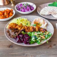Chicken Kabob Plate · Served with chicken kabob skewers (2), Mediterranean sides (5), sauces, and a freshly-baked ...