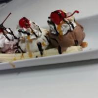 Banana Split · Banana split with your choice of 3 ice cream flavors, 1 topping, and 1 sauce.