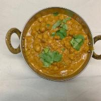 83. Channa Masala · Protein rich garbanzo beans with onions, tomatoes and tamarind sauce. Vegan.