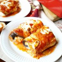 Eggplant Rollatine · 3 pieces of fried eggplant, rolled with seasoned ricotta and Romano cheese, topped with sauc...