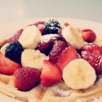 Fresh Fruit Waffle · Golden brown waffle dusted with powdered sugar and topped with sliced bananas, seasonal berr...