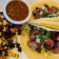 Filet Mignon Tacos Specialty  · Seasoned and grilled filet mignon, onions, cilantro, served with black bean corn salad. Extr...