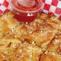 Garlic Parmesan Bread · Fresh pizza dough cooked fluffy and sprinkled with parmesan cheese. Made to order with love ...