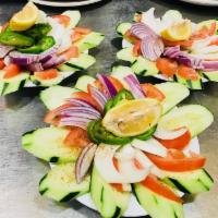 Indian Salad · Fresh cut onions, cucumber, tomatoes and green chilies platter with lemon and sprinkled with...