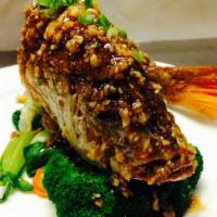 Garlic Fish · Crispy whole red snapper topped with garlic sauce.