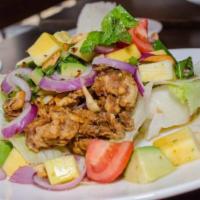 Rain Soft Shell Crab · Fried soft shell crab with mango, avocado, red onion, cashew nuts with spicy lime dressing. 