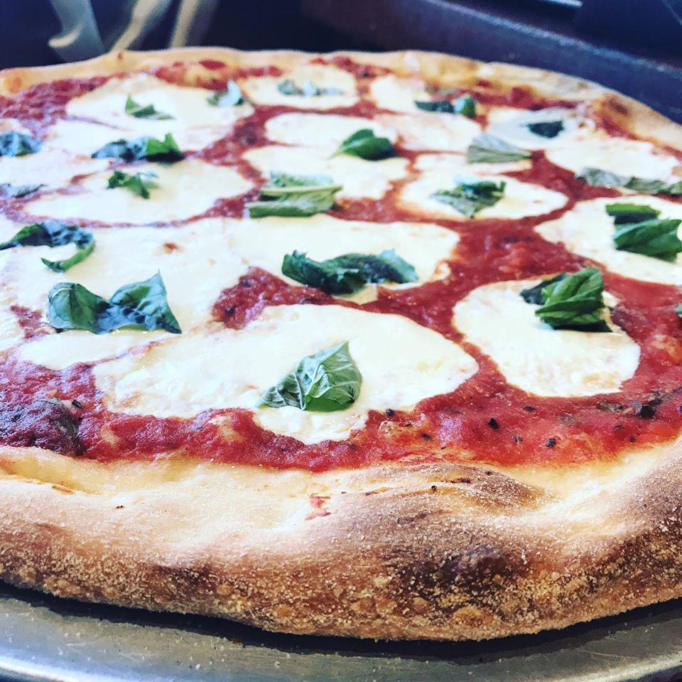 Margherita Pizza · Traditional Neapolitan style thin crust pizza topped with our crushed San marzan plum tomato sauce, fresh mozzarella and basil. 