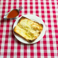 Garlic Bread · Italian bread, split open and spread with our garlic butter, Italian seasonings, & oven toas...
