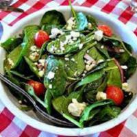 Spinach Salad · Spinach in a raspberry vinaigrette with walnuts, dried cranberries, apple slices, topped wit...
