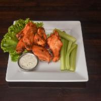 BUFFALO WINGS · Wings and drumettes in buffalo sauce with celery and bleu cheese.