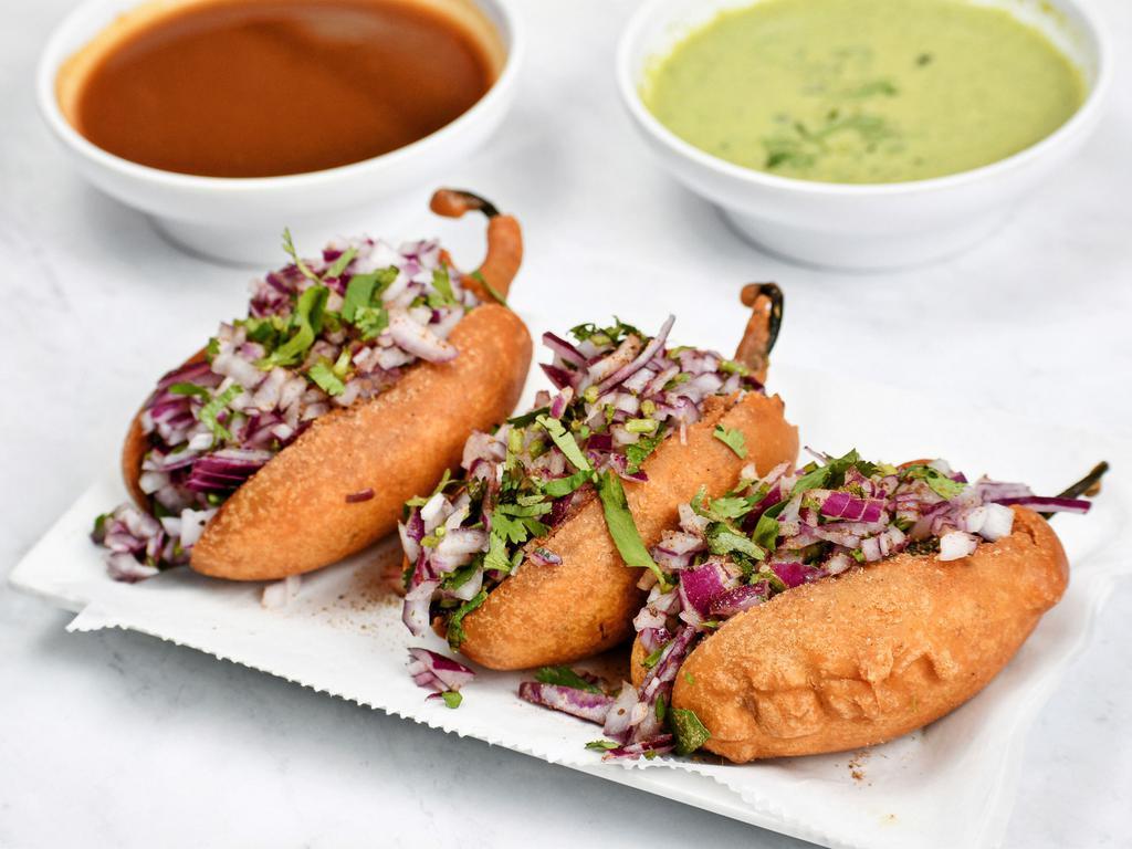 Onion Mirchi Bajji (3 Piece) · Whole jalapenos fried with spiced chick pea flour and stuffed with onions.
