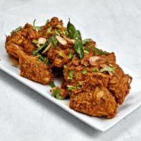Goat Sukha · Goat tender pieces marinated and cooked with Indian spices and curry leaves.