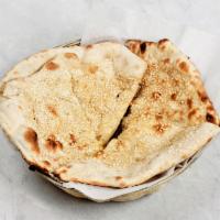 Sesame Naan · Traditional Indian bread baked in clay oven topped with sesame seeds.