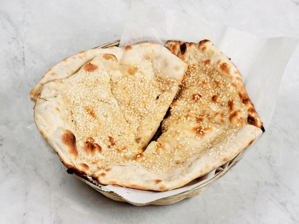 Sesame Naan · Traditional Indian bread baked in clay oven topped with sesame seeds.