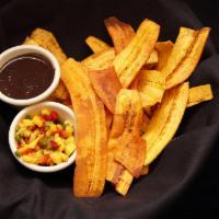 Tostaditos de Platano · Crispy fried plantains chips served with black bean dip and salsa Caribbean.