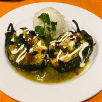 Chiles Relleno · 2 poblano peppers stuffed with sauteed mushrooms, sweet corn, red peppers, celery, carrots, ...