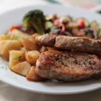 Pork Chops · 2 grilled, juicy and tender boneless pork loin chops, served with mashed or garlicky roasted...