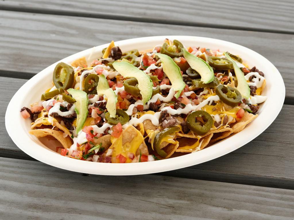 Nachos · Fresh made chips topped with choice of meat, beans, cheese sauce, shredded cheese, fresh salsa, sour cream, avocado and jalapenos.