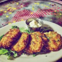 Hearty Crab Cakes · Gluten-free. Three crab cakes with hearts of palm and artichoke hearts served with vegan tar...