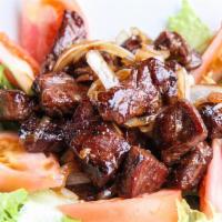 Shakin’ Steak (BO LUC Lac) · Bo luc lac. Tender marinated steak cubes tossed with onions and served over a bed of lettuce...