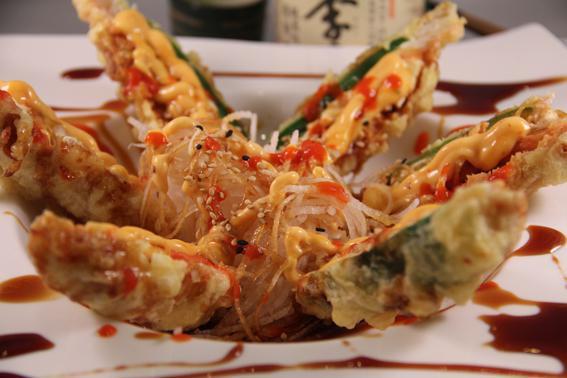 Heart Attack · 3 jalapeno peppers stuffed with cream cheese, crab stick and spicy tuna, deep fried and served on a bed of daikon. Topped with teriyaki sauce, spicy mayo, sesame sauce and sriracha.