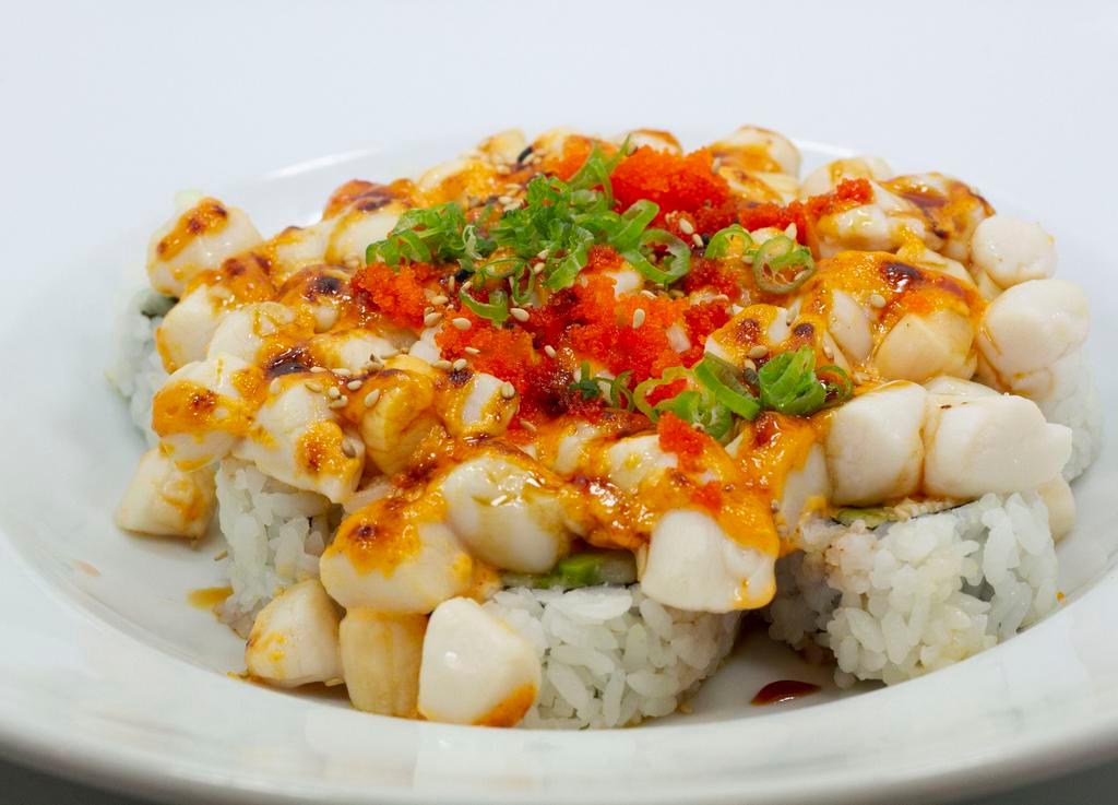 Crazy Fish Dynamite Roll · Baked baby scallops, mayo, eel sauce, fish eggs and scallions top of California roll.