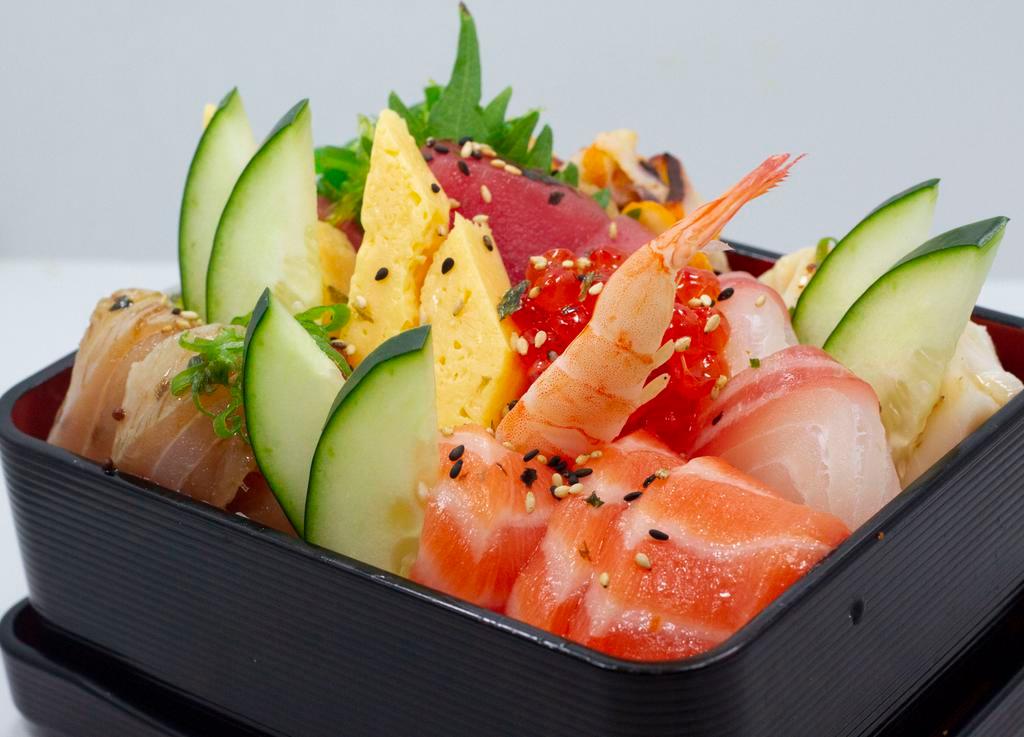 Chirashi Sashimi Bowl · Rice bowl covered in colorful slices of tuna, salmon, yellowtail, albacore, white fish, white tuna, shrimp, salmon eggs, seaweed salad and sweet omelet.