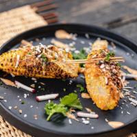 Jerk Corn on the Cob · Toasted Coconut Flakes and Jerk Butter